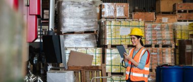 Warehouse worker checking the quantity of storage products on the shelf  in the warehouse., Industrial and industrial concept.