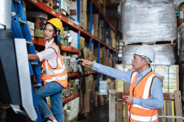 Warehouse worker checking the quantity of storage products on the shelf  in the warehouse., Industrial and industrial concept.