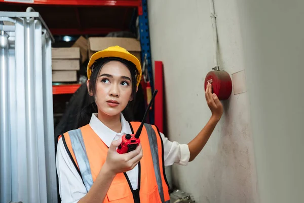 Women warehouse workers use talkie of an emergency in a factory worker to be able to cope in time.