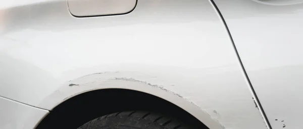 Stock image Deep scratches and paint damage on a bumper vehicle. car scratch and dent. accident involving a car crash