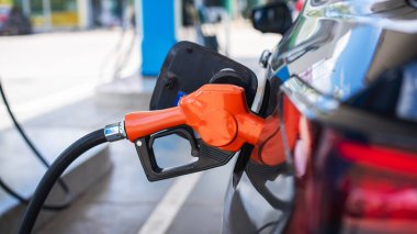 Gasoline being refilled at a petrol station. Refueling Diesel fuel is used to power a car.	