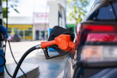 Gasoline being refilled at a petrol station. Refueling Diesel fuel is used to power a car.	