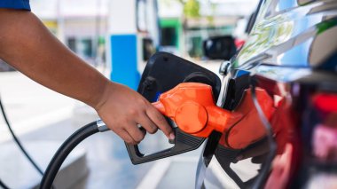 Gasoline being refilled at a petrol station. Refueling Diesel fuel is used to power a car.	