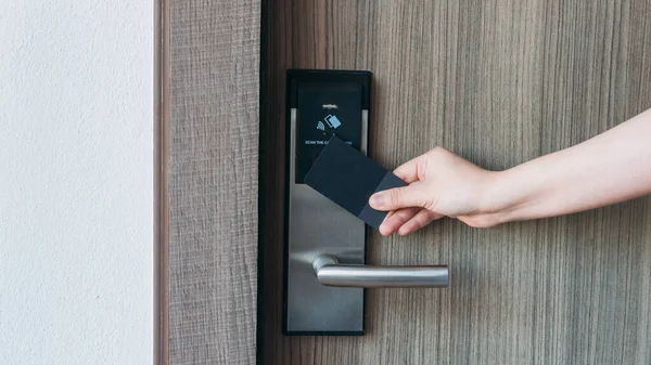 Electronic card key for open door in hotel. Smart card key to lock and unlock door. Security systems and protection concept.