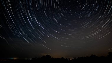 Star trails in the night sky. Stars move around a polar star