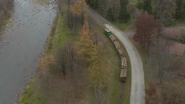 沿着一条狭窄的旧铁路线运送木材的货运列车的空中景观 乌克兰喀尔巴阡山脉的木材采伐业 — 图库视频影像