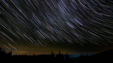 Star trails in the night sky. Stars move around a polar star