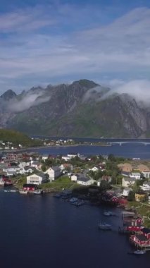 Norveç 'in Lofoten adalarındaki Resimli balıkçı kasabası Reine' in hava manzarası güneşli yaz gününde popüler turizm beldesi, dikey görüntüler