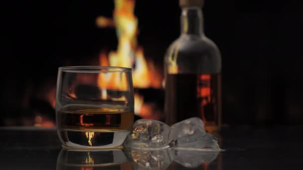 Glass Bottle Whiskey Scotch Bourbon Stands Table Background Fireplace Flame — Stock Video