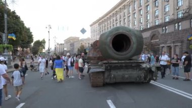 KYIV, UKRAINE - AUG 22, 2022: Destroyed Russian military equipment in the center of Kyiv on Khreshchatyk. People inspect and photograph captured Russian tanks on Ukraines Independence Day.