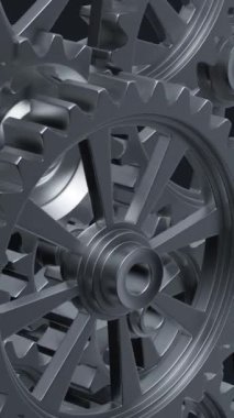 Yakından bakıldığında, mekanik tasarımın karmaşıklığını ve mühendisliğini vurgulayan bir dizi birbirine kenetlenmiş metal vites görülüyor. dikey görüntüler