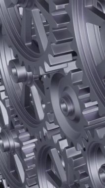 Yakından bakıldığında, mekanik tasarımın karmaşıklığını ve mühendisliğini vurgulayan bir dizi birbirine kenetlenmiş metal vites görülüyor. dikey görüntüler