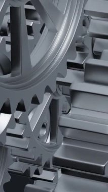 Yakından bakıldığında, mekanik tasarımın karmaşıklığını ve mühendisliğini vurgulayan bir dizi birbirine kenetlenmiş metal vites görülüyor. dikey görüntüler