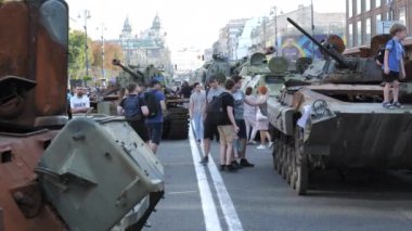 KYIV, UKRAINE - AUG 22, 2022: Destroyed Russian military equipment in the center of Kyiv on Khreshchatyk. People walk and take pictures of captured Russian tanks on the day of independence of Ukraine.