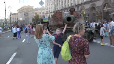KYIV, UKRAINE - AUG 22, 2022: Destroyed Russian military equipment in the center of Kyiv on Khreshchatyk. People inspect and photograph captured Russian tanks on Ukraines Independence Day.