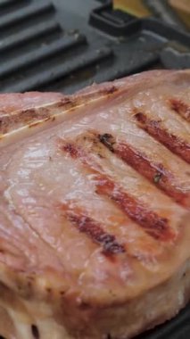 Biberiyeli lezzetli biftek elektrikli ızgarada pişirilir. Yıllanmış az pişmiş ızgara sığır filetosu taze mermer hassasiyet bifteği. Elektrikli kızartma makinesinde kızarmış et. dikey görüntüler