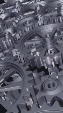Yakından bakıldığında, mekanik tasarımın karmaşıklığını ve mühendisliğini vurgulayan bir dizi birbirine kenetlenmiş metal vites görülüyor. dikey görüntüler