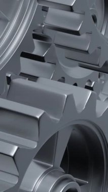 Yakından bakıldığında, mekanik tasarımın karmaşıklığını ve mühendisliğini vurgulayan bir dizi birbirine kenetlenmiş metal vites görülüyor. dikey görüntüler
