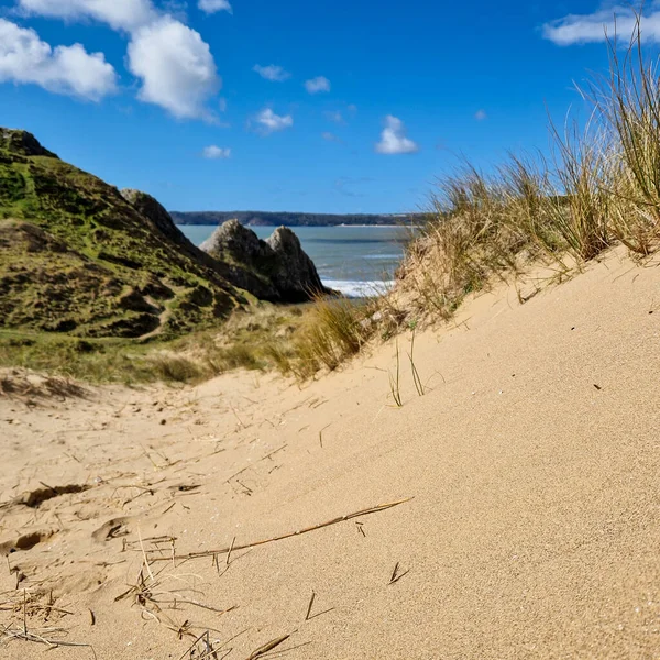 stock image The three cliffs are visible in the background, with their sharp angles and rugged textures adding an element of drama to the scene. The calm, clear waters of the bay provide a perfect backdrop for surfing, swimming, or simply enjoying a peaceful day