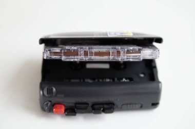 Beyaz arka planda açık deste ve kaset olan eski bir teyp, eski arşiv kayıtları.