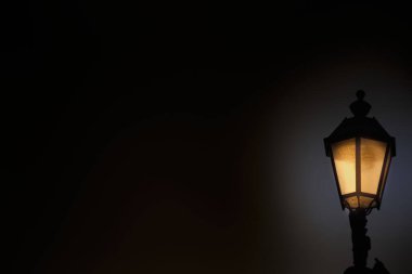 Gece gökyüzüne karşı parlayan eski bir gaz feneri