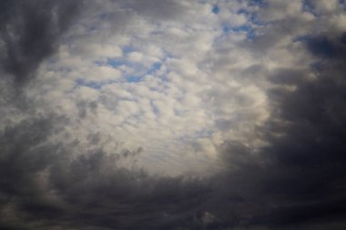 Gökyüzünün panoramik manzarası. Mavi gökyüzündeki gri bulutlar, değişen hava, gökyüzü arka planı..