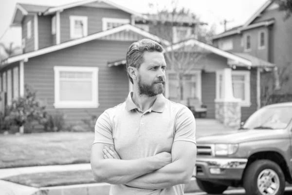 bearded man homeowner selling or renting house, neighborhood.