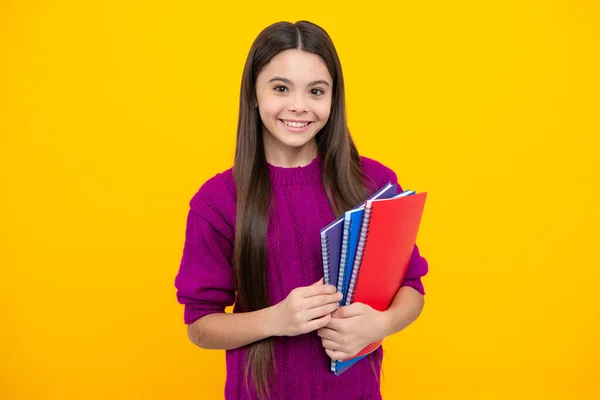 Stock image Teen girl pupil hold books, notebooks, isolated on yellow background, copy space. Back to school, teenage lifestyle, education and knowledge