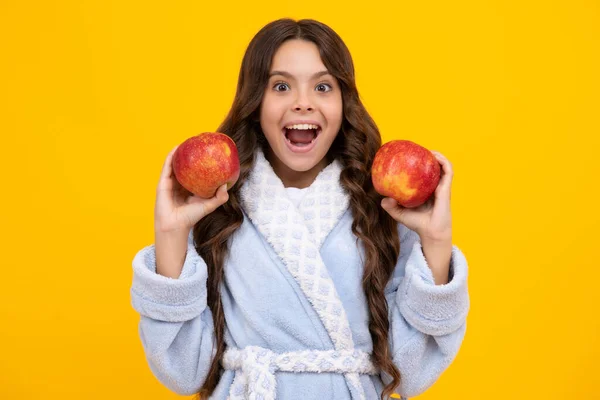 stock image Fresh fruit. Teenager girl hold apples on yellow isolated studio background. Child nutrition. Amazed teen girl. Excited expression, cheerful and glad