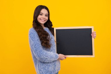 Little girl teen with blackboards. Teenager school girl hold blackboard for copy space, school sale. Happy teenager, positive and smiling emotions of teen girl