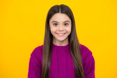 Close up emotional portrait of caucasian smiling teen girl. Head shot of cute teenager child on isolated studio background