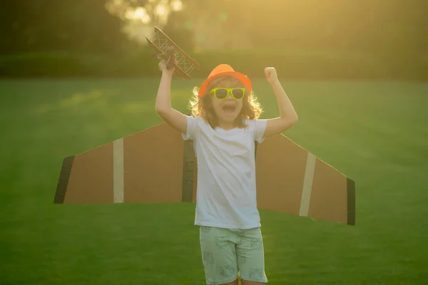 stock image The concept of child kindness and childhood. Kid playing with toy airplane and dreaming future. Happy boy pilot play with airplane outdoors