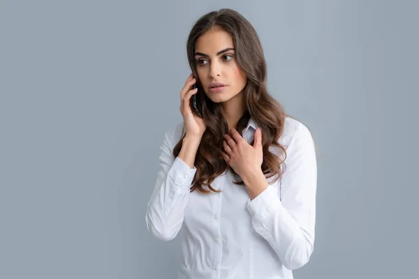 stock image Serious woman with smart phone. Young woman with mobile phone. Businesswoman with smartphone on grey background