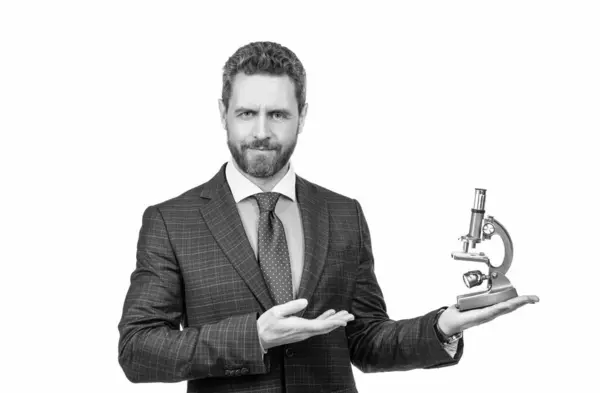 stock image handsome entrepreneur man in businesslike suit presenting modern microscope isolated on white, scientific method.