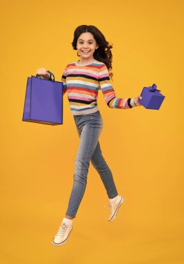 Teenager hold shopping bag enjoying sale. Child girl is ready to go shopping. Happy teenager, positive and smiling emotions of teen girl