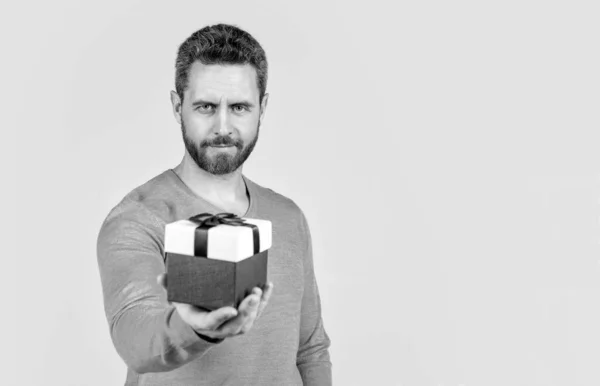 stock image handsome mature man with beard taking present box, selective focus and copy space, shopping.