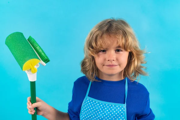 Child doing housework. Child mopping house, cleaning home. Detergents and cleaning accessories. Cleaning service. Little boy housekeeping