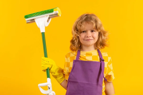 Child doing housework. Child use duster and gloves for cleaning. Funny child mopping house. Cleaning accessory, cleaning supplies. Housekeeping and home cleaning