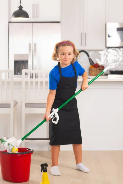 Kid helping with housework, cleaning. Portrait of child helping with housework, cleaning the house. Housekeeping, home chores