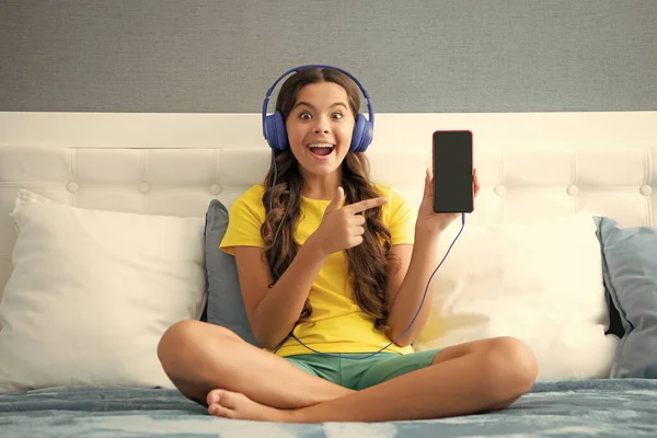 Teenager Child Girl Wearing Headphones Listening Music Smart Phone Sitting — Stockfoto