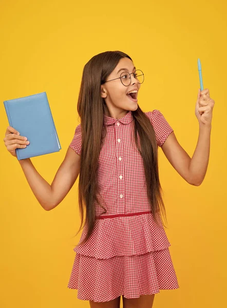 stock image Amazed teen schoolgirl. School child with book. Learning and education. Excited expression, cheerful and glad