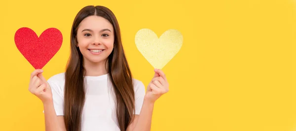happy valentines day. be my valentine. teen girl on yellow background. love present. Kid girl portrait with heart love symbol, horizontal poster. Banner header with copy space