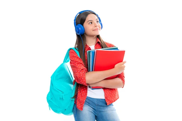 stock image Schoolchild, teenage student girl with headphones and school bag backpack on white isolated studio background. Children school and education concept