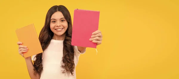 stock image smiling school child ready to study show notepad, school. Horizontal isolated poster of school girl student. Banner header portrait of schoolgirl copy space