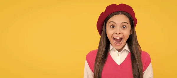 stock image surprised teen school girl in french beret on yellow background, happiness. Child face, horizontal poster, teenager girl isolated portrait, banner with copy space