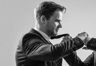 Attacked at work. Manager being pulled by necktie. Fighting and conflict. Professional man fight with coworker. Physical fighting.