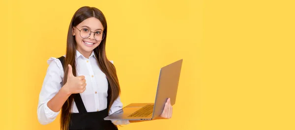 typing school blog. impact of computer on vision. kid in glasses. teen girl use laptop for communication. modern education. back to school. happy child study online. computer vision syndrome. thumb up