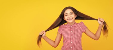 Children studio portrait on yellow background. Childhood lifestyle concept. Child face, horizontal poster, teenager girl isolated portrait, banner with copy space