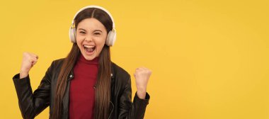 listen to music. wireless headset device accessory. new technology. Child portrait with headphones, horizontal poster. Girl listening to music, banner with copy space