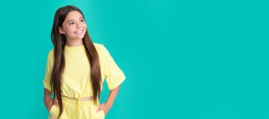 Mutlu çocuğun mavi arka planda uzun saçları var güzelim. Çocuk yüzü, yatay poster, izole edilmiş genç kız portresi, fotokopi alanı olan pankart